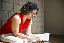 Florence Dallo sitting on a bench, reading a book